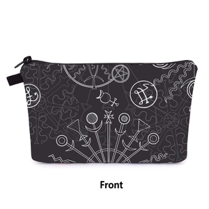 Close-up of black digital print makeup bag with white occult symbols and starry patterns