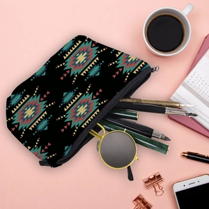 Flat lay of mandala cosmetic bag with tribal patterns, sunglasses and pens inside