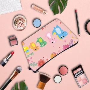 Flat lay of pink dinosaur makeup bag with brushes, lipstick and eyeshadow palette
