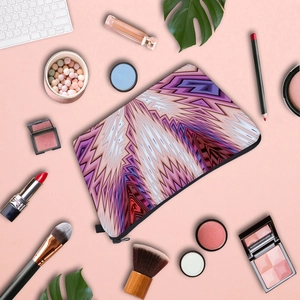 Flat lay of geometric pattern makeup bag with purple zig-zag texture and cosmetic accessories