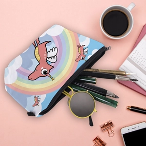 Flat lay of a waterproof makeup bag with pink dinosaur pattern and lifestyle accessories