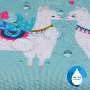 Detailed view of water-resistant llama print fabric showing high-density hydrophobic drops