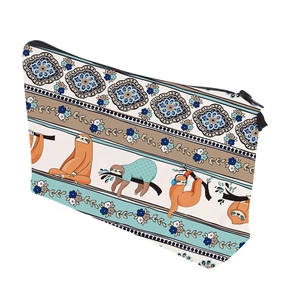 Close-up of waterproof cosmetic bag with lazy sloths and mandala patterns on white fabric