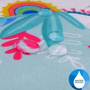 Macro view of water-resistant tropical print fabric with water droplets on the cosmetic bag
