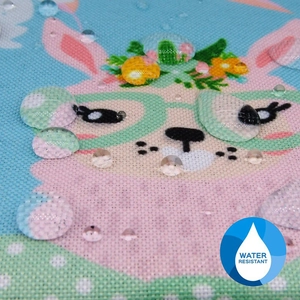 Detail shot of alpaca printed fabric showing water resistant surface with droplets