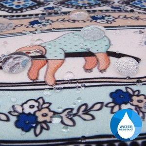 Close-up of waterproof fabric showing water droplets on the sloth print cosmetic bag