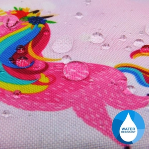 Detail of pink alpaca coin purse fabric showing clear water drops on water resistant coating