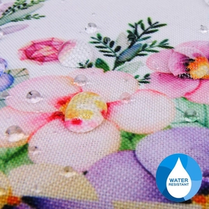 Detail of water resistant floral printed fabric showing water drops on the coin purse surface