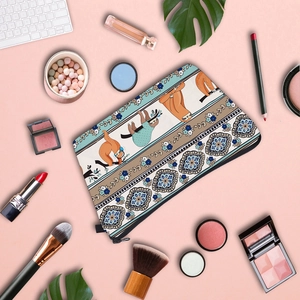 Detailed top view of waterproof sloth print makeup bag with cosmetics and keyboard accessories