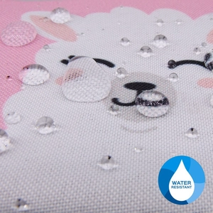 Macro shot of water resistant fabric showing clear water drops on the cute alpaca pattern