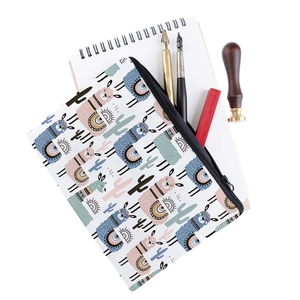 Close-up of square makeup bag with cartoon alpaca and cactus prints on white canvas