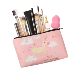 Pink unicorn cosmetic bag for travel storage, showing makeup brushes and skincare items