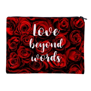 Detail of red rose pattern makeup bag featuring Love beyond words text and zipper
