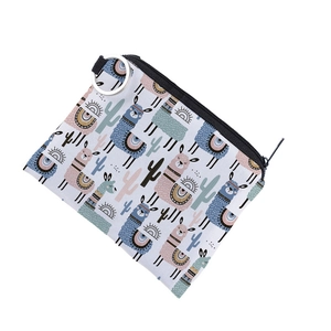 Close-up of llama print coin purse with a durable zipper and metal keyring attachment