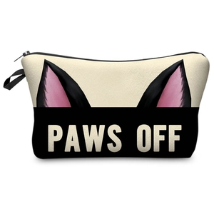 Detail view of the fabric texture and PAWS OFF cat ear print on the canvas makeup bag