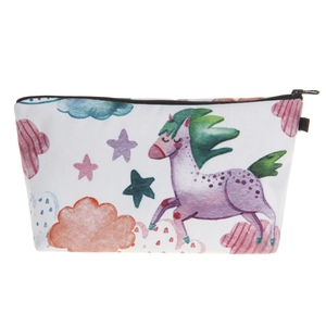 Detail of floral makeup bag with purple cartoon pony and star patterns on canvas fabric