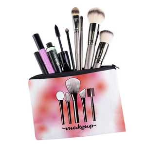 Detail of a floral makeup bag with pink watercolor print and black zipper storage