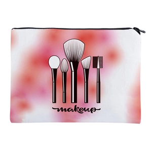 Detail of canvas makeup bag featuring red gradient print and makeup brush graphic