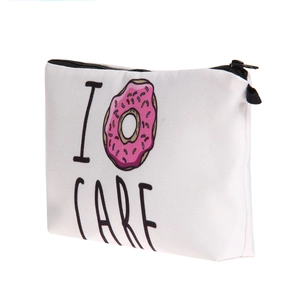 Close-up of canvas makeup bag featuring a pink donut print and I Donut CARE slogan