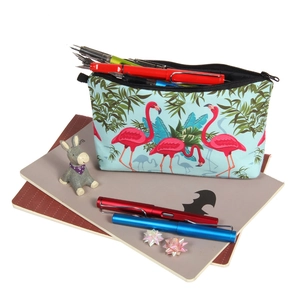 Light blue canvas makeup bag with flamingo and palm leaf print, showing its large capacity