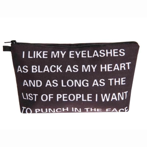 Detail of black canvas toiletry bag with zipper and funny quote print for travel