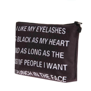Detail of black makeup bag with white printed typography and secure zipper closure