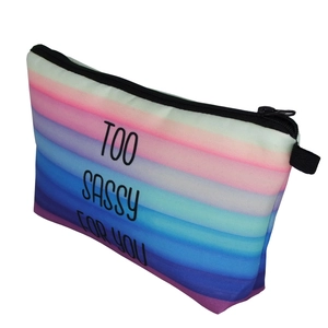 Side view of rainbow striped makeup bag with black zipper and Too Sassy For You slogan