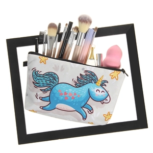 Portable white makeup bag with blue unicorn print filled with cosmetics in a black frame