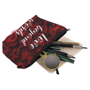 Cosmetic bag with dark red rose patterns and Love Beyond Words print on light wood background