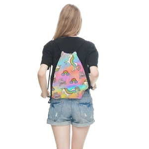Rainbow unicorn drawstring bag with Oh Yeah text being worn by a model against white wall