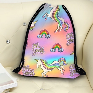 Rainbow unicorn drawstring bag with Oh Yeah print on a sofa for travel and storage