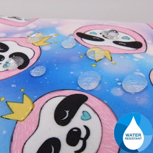 Close-up of water-resistant fabric with panda print showing water droplets on the surface