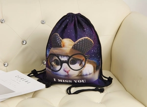 Detail of drawstring bag featuring a galaxy cat print on a cream leather sofa