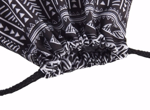 Close-up of geometric pattern drawstring bag showing black and white tribal print and cords
