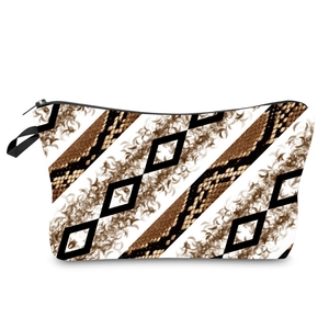 Detail showing diagonal stripe ink print and snake texture on the travel makeup bag