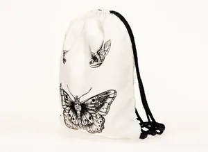 White drawstring backpack with black butterfly and bird print on polished white surface