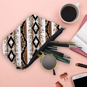 Diamond pattern ink print makeup bag with snake skin detail on pink background