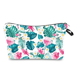 Floral print makeup bag with pink hibiscus flowers and tropical leaves for travel