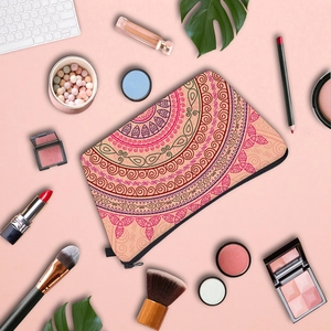 Pink travel cosmetic bag featuring symmetrical mandala print and black zipper closure