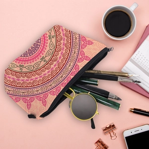 Pink mandala printed travel organizer bag with stationery and coffee on flat lay desk
