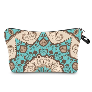 Detail of blue mandala print makeup bag featuring zipper closure and sturdy wristlet strap