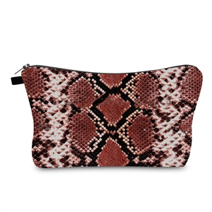 Detail shot of the snake skin pattern and durable black zipper on the makeup bag