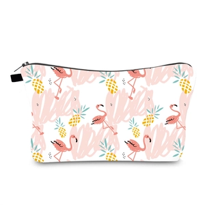 Close-up of bird and pineapple digital print on a white makeup bag with black zipper