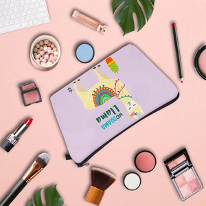 Flat lay of purple llama makeup bag with digital print on desk with cosmetics