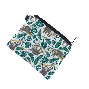 Close-up of canvas coin purse featuring cartoon sloth print and silver key ring attachment