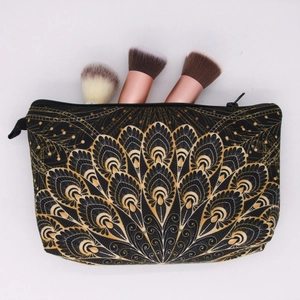 Mandala print makeup bag in black fabric with gold feather pattern and zipper closure