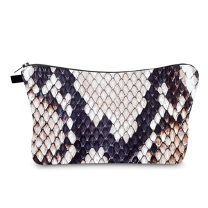 Detail shot of the faux snakeskin pattern and black metal zipper on the makeup bag