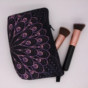 Detail of digital print mandala cosmetic bag with zipper and rose gold brushes