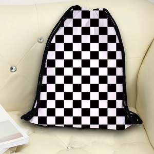 Unisex black and white checkerboard drawstring backpack on a cream leather sofa