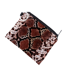 Detail of snake print coin purse with brown pattern, black zipper and metal ring